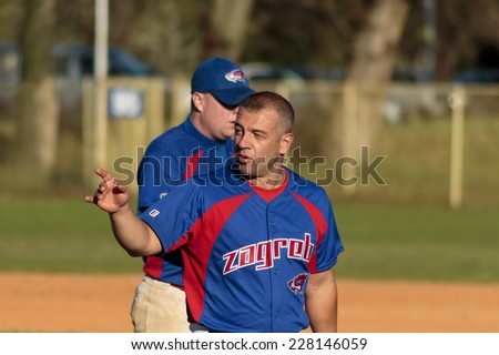 ZAGREB. CROATIA - OCTOBER 12, 2014: Baseball match Baseball Club Zagreb in blue jersey and Baseball Club Olimpija in dark blue jersey. Unidentified baseball player greets supporters in the stands