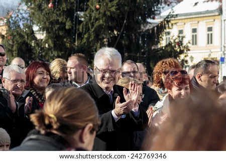SAMOBOR, CROATIA - JANUARY 04, 2015: Ivo Josipovic the third President of Croatia on the promotion for the next presidential election in Croatia. The President is smiling and clapping hands.