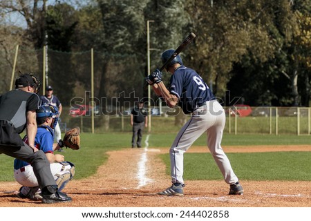 ZAGREB. CROATIA - OCTOBER 12, 2014: Baseball match Baseball Club Zagreb in blue jersey and Baseball Club Olimpija in dark blue jersey. Unidentified baseball batter,plate umpire and catcher on field