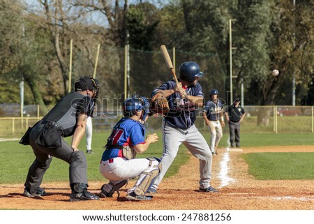 ZAGREB. CROATIA - OCTOBER 12, 2014: Baseball match Baseball Club Zagreb in blue jersey and Baseball Club Olimpija in dark blue jersey. Unidentified baseball batter is about to hit the ball