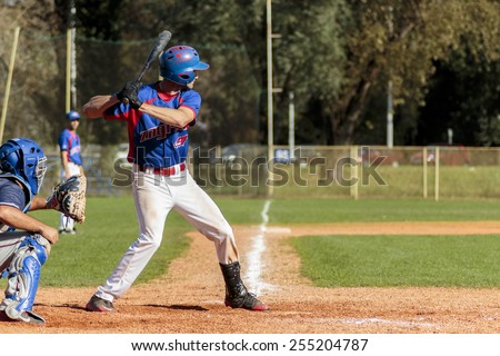 ZAGREB, CROATIA - OCTOBER 12, 2014: Baseball match Baseball Club Zagreb in blue jersey and Baseball Club Olimpija in dark blue jersey. Unidentified baseball batter, catcher and plate umpire