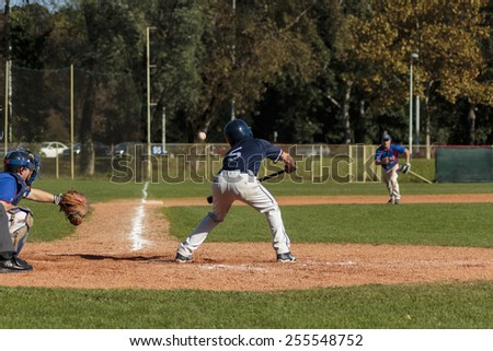ZAGREB, CROATIA - OCTOBER 12, 2014: Baseball match Baseball Club Zagreb in blue jersey and Baseball Club Olimpija in dark blue jersey. Unidentified baseball batter hits the ball