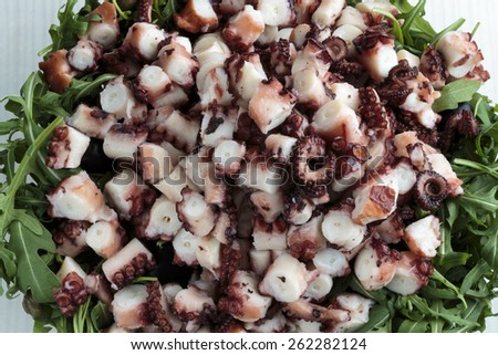Sliced octopus and rucola leaves prepared for salad