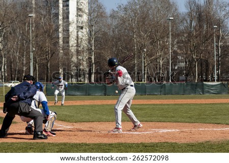 ZAGREB, CROATIA - MARCH 21, 2015: Baseball match Baseball Club Zagreb in blue jersey and Baseball Club Olimpija in gray jersey. Unidentified baseball batter is about to hit the ball