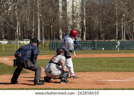 ZAGREB, CROATIA - MARCH 21, 2015: Baseball match Baseball Club Zagreb in blue jersey and Baseball Club Olimpija in gray jersey. Baseball batter is about to hit the ball