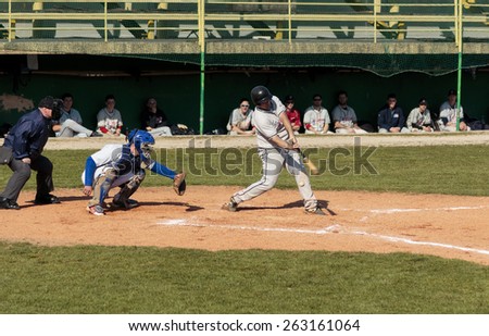 ZAGREB, CROATIA - MARCH 21, 2015: Baseball match Baseball Club Zagreb in blue jersey and Baseball Club Olimpija in gray jersey. Unidentified baseball batter miss the shot