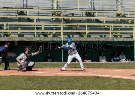 ZAGREB, CROATIA - MARCH 21, 2015: Baseball match Baseball Club Zagreb in blue jersey and Baseball Club Olimpija in gray jersey. Baseball batter catcher and plate umpire