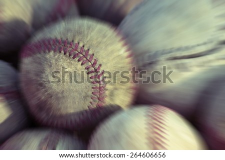 Old baseball balls close up background.  Post processed with vintage filter and zoom blur.