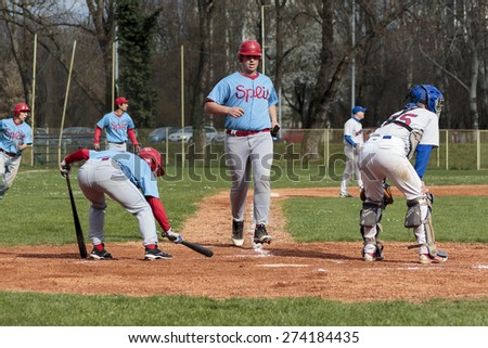ZAGREB, CROATIA - MARCH 28, 2015: Baseball match Baseball Club Zagreb in white jersey and Baseball Club Nada in blue jersey. Baseball players on field.