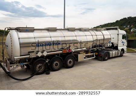 ZAGREB, CROATIA - JUNE 23, 2015: Tank truck unloading dangerous flammable goods Isopropyl alcohol into the inner tank storage of chemicals warehouse