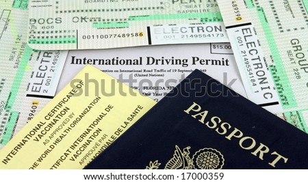 Collection of Travel Documents - Passport, International Driving Permit, International Vaccination Certificate and Airline Boarding Passes.