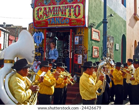 BUENOS AIRES, ARGENTINA - OCTOBER 12: A street band plays in the La Boca district of Buenos Aires, Argentina October 12, 2006. La Boca is a tourist attraction and where the Tango originated.