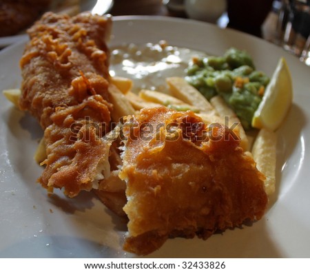 Fish and chips with smashed at a cafe in London, England.