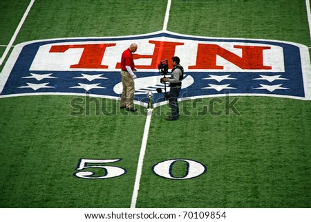 ARLINGTON - JAN 26: In preparation for Super Bowl XLV an unidentified cameraman and worker discuss placement of the trophy in Cowboys Stadium in Arlington, TX. Taken January 26, 2011 in Arlington, TX.