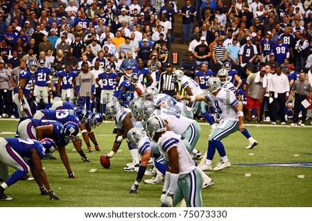DALLAS - DEC 14:  Dallas Cowboys Quarterback Tony Romo points to a New York Giants defender as he calls signals. Taken in Texas Stadium on Sunday, December 14, 2008.