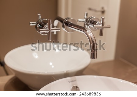 Side view of Faucet and marble sink in the luxury hotel