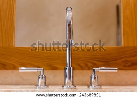 Front view of Faucet and marble sink in the luxury hotel