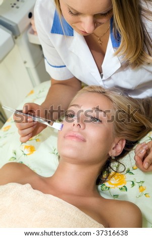 Woman and cosmetologist in the beauty salon