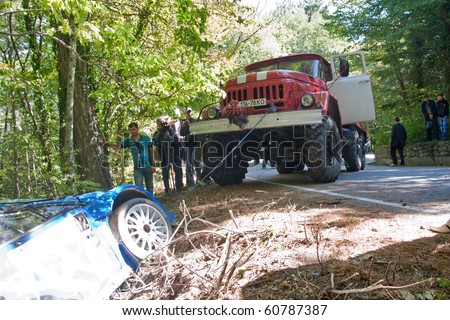 SEVASTOPOL, UK-11 SEPTEMBER: Fire truck pulls from the side of the car crashed Super 2000 Ford Fiesta, Race Yalta Prime Rally, September 11, 2010 in Yalta, Ukraine.