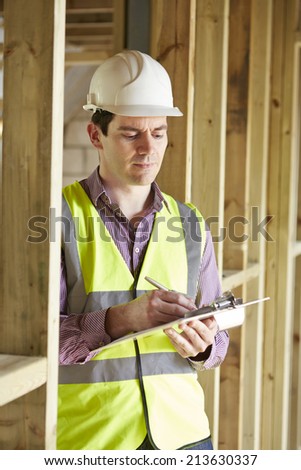 Building Inspector Looking At New Property