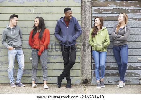 Gang Of Teenagers Hanging Out In Urban Environment