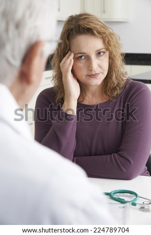 Worried Plus Size Woman Meeting With Doctor In Surgery