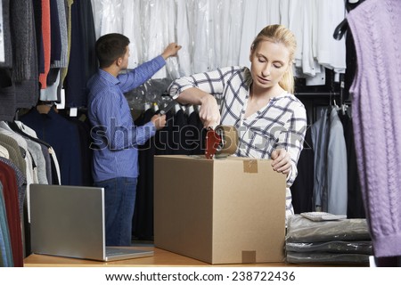 Couple Running On Line Clothing Store Packing Goods For Dispatch