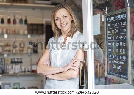 Owner Of Gift Shop Standing In Doorway