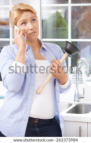 Frustrated Woman Calling Plumber To Fix Blocked Sink At Home