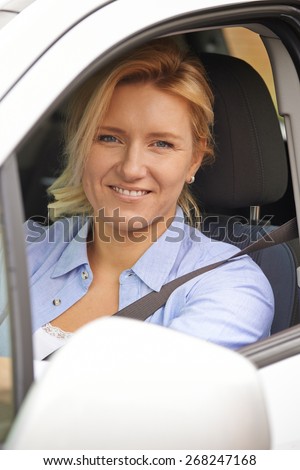 Portrait Of Female Driver Looking Out Of Car Window