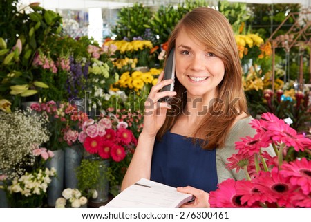 Florist In Shop Taking Order Over The Phone In Shop