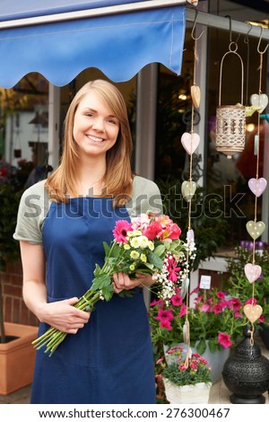 Florist Standing Outside Florist Shop With Bouquet