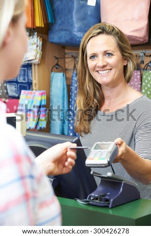Shopper Paying For Goods Using Credit Card Machine