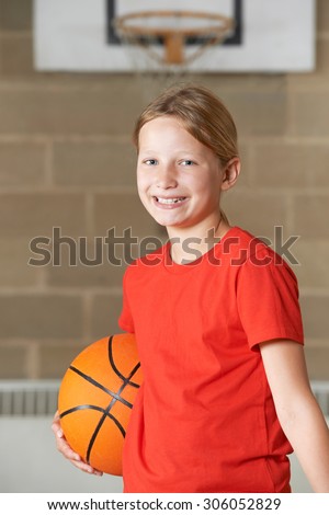 Portrait Of Girl Holding Basketball In School Gym