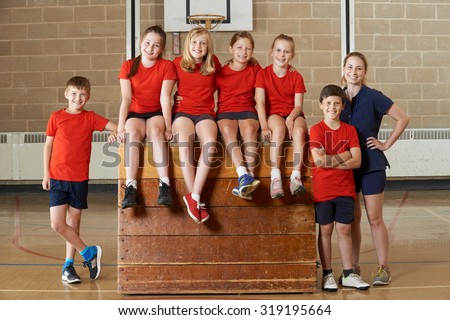 Portrait Of School Gym Team Sitting On Vaulting Horse