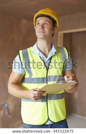 Building Inspector Looking At New Property