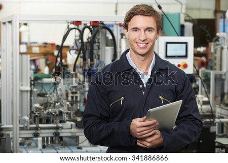 Engineer In Factory Holding Digital Tablet