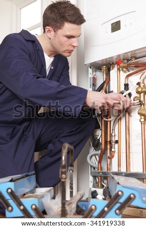 Engineer Servicing Central Heating Boiler
