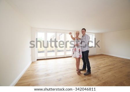 Young Couple With Keys To New Home