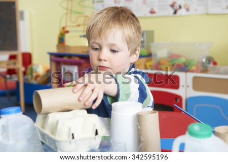 Boy Building Junk Model In Pre School Class