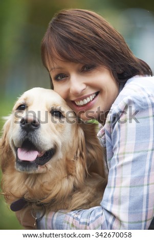 Woman Hugging Pet Golden Retriever
