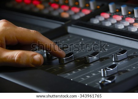 Close Up Of Recording Engineer Pushing Fader In Studio