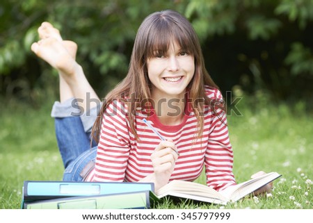 Young Female Student Studying In Park