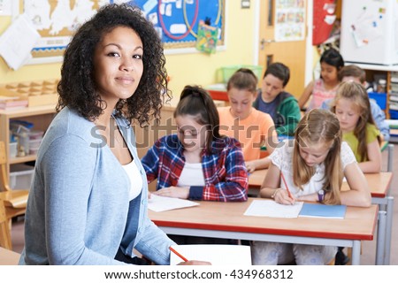 Portrait Of Teacher In Class With Pupils
