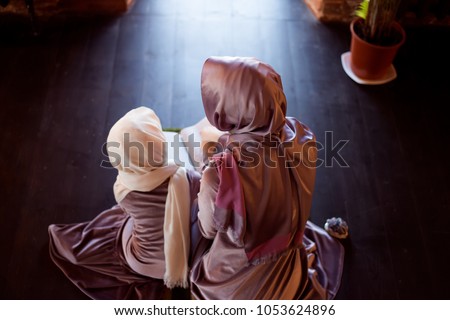 Muslim woman teaches children to read the Quran