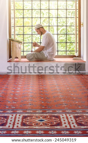 A man in a mosque near the window