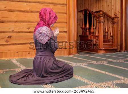 young woman praying in the mosque