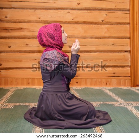 young woman praying in the mosque