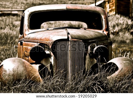 Objects in various stages of decay and aging, abandoned and forgotten - abandoned car.