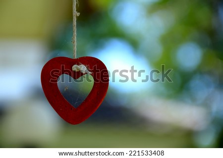 Love  heart shape  hanging on rope in garden with space beside